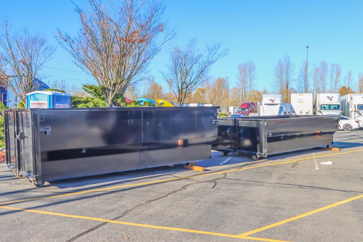 Professional dumpster rental service with roll-off container on residential driveway in Star